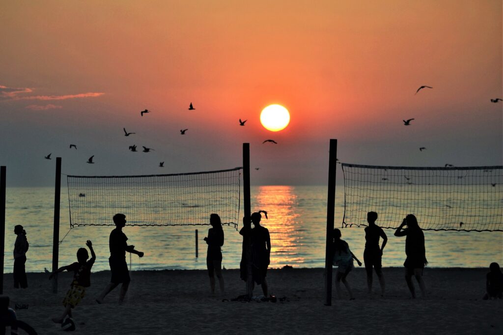 Volleyball at the beach with orange sunset